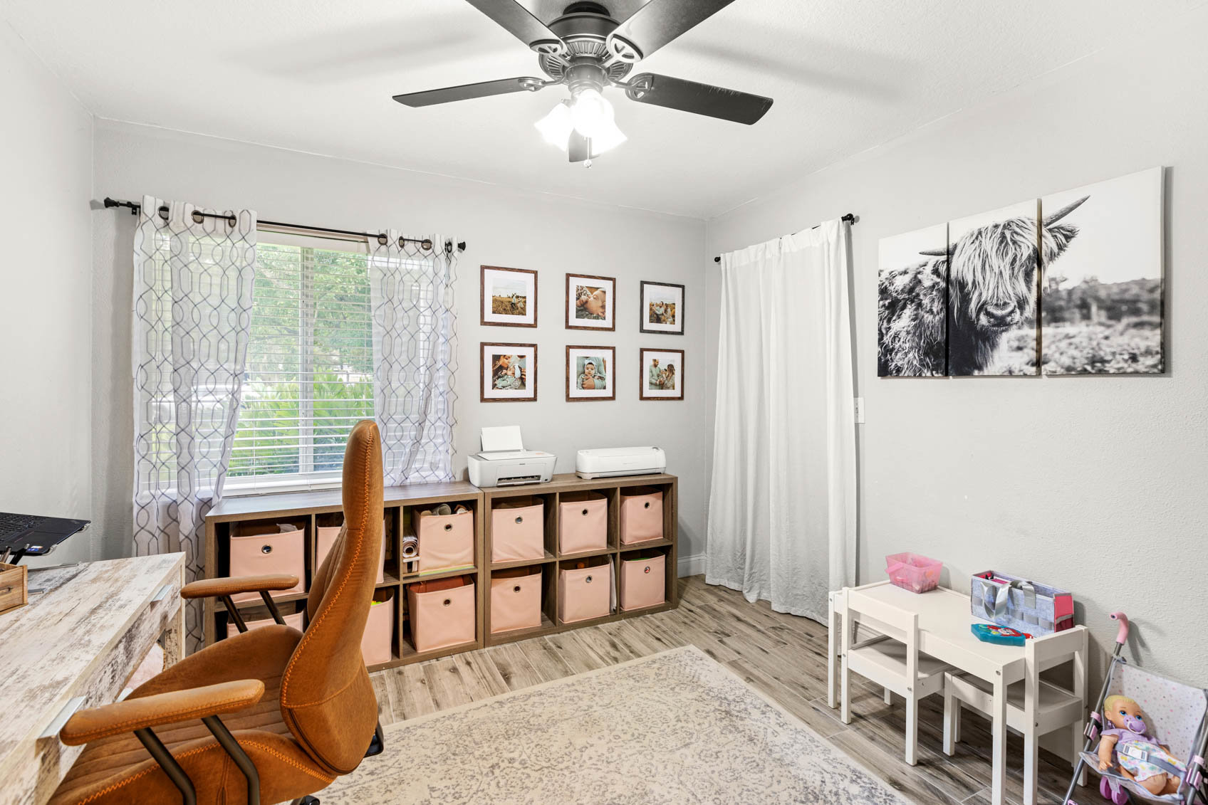 bedroom converted office with desk and small kids table